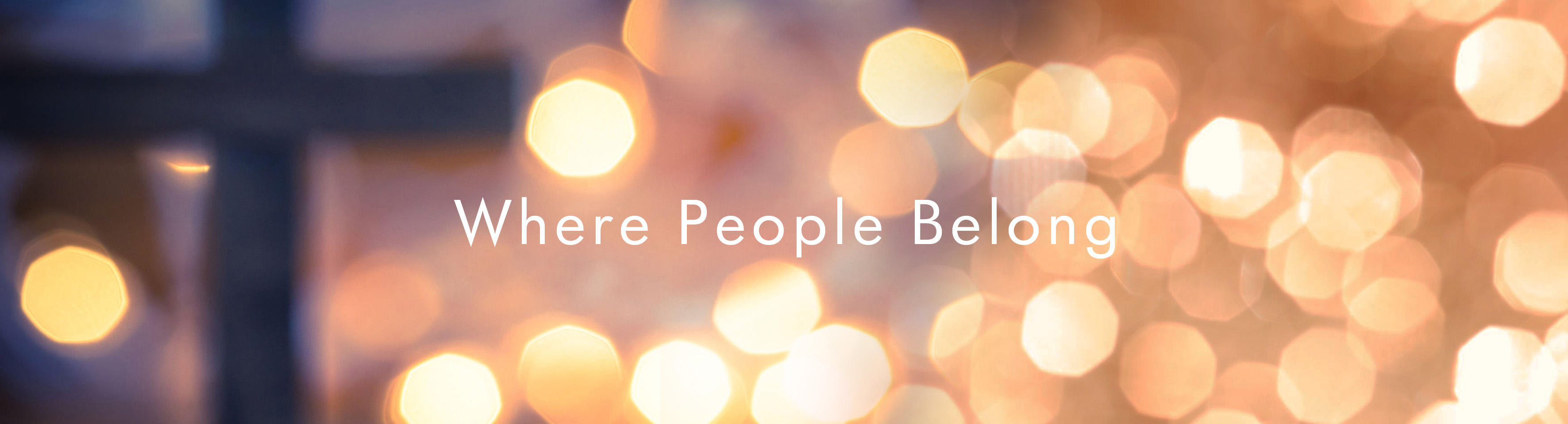 Cross with warm bokeh lights — Where People Belong
